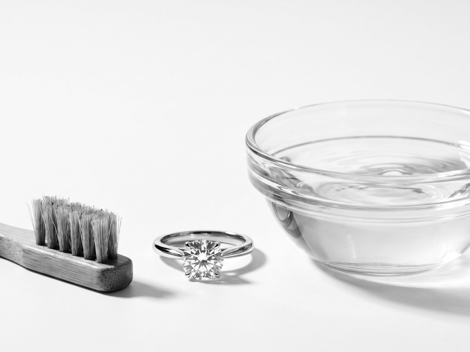 Ring beside a cleaning brush and water