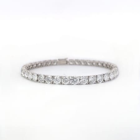 A 4.00ct tdw round brilliant cut natural mined diamond tennis bracelet in silver, showcasing sparkling diamonds evenly spaced around the band, set against a clean white background.