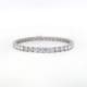 A 4.00ct tdw round brilliant cut natural mined diamond tennis bracelet in silver, showcasing sparkling diamonds evenly spaced around the band, set against a clean white background.