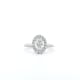 The 1ct Oval Natural Diamond Halo Engagement Ring is showcased on a white background, featuring a stunning silver design with an oval-shaped diamond center stone encircled by a halo of smaller diamonds on a simple band.