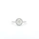 The "1ct Round Brilliant Cut Natural Diamond Halo Engagement Ring" features a large round diamond at its center, encircled by smaller diamonds in an elegant halo setting and is beautifully showcased against a white background.