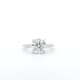 A simple, elegant silver engagement ring featuring a large, round lab diamond centerpiece set against a white background.