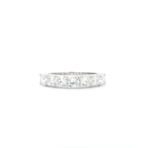 The 2.52ct Cushion Lab Diamond Half Eternity Ring features a series of large, sparkling white stones set across the silver band, showcased against a plain white background.