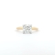 A gold engagement ring with a 2-carat cushion-cut natural diamond and hidden halo is set in a four-prong setting against a plain white background.