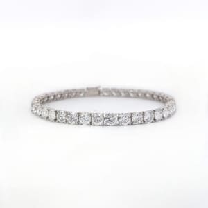 A dazzling 2ct lab-grown diamond tennis bracelet crafted in 14k white gold, featuring a continuous line of round diamonds set within an exquisite, slender band against a plain white background.
