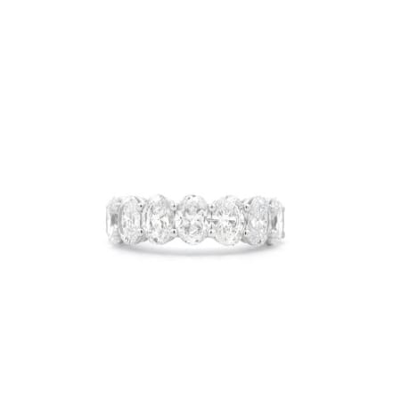 The 3.55ct Oval Lab Diamond Half Eternity Ring showcases a series of oval-shaped clear gemstones set in a single row, elegantly displayed on a plain white background.