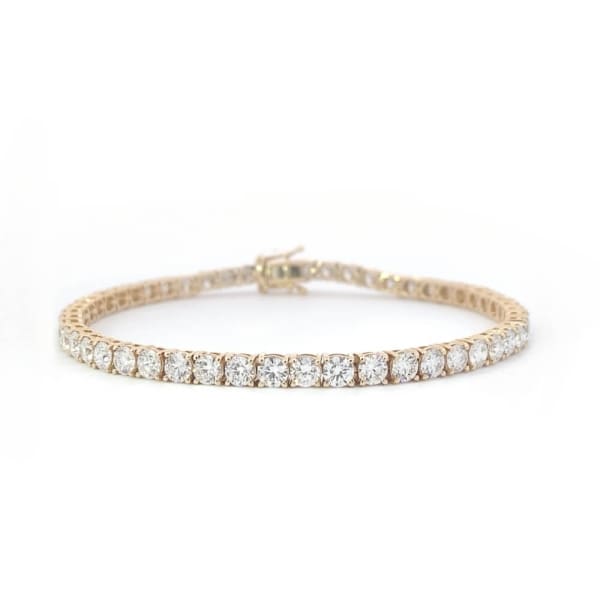 This 5.27ct lab-grown diamond tennis bracelet, set in 14k yellow gold, features a continuous line of dazzling round diamonds against a white background. Elegantly crafted, it showcases a classic and sophisticated design.