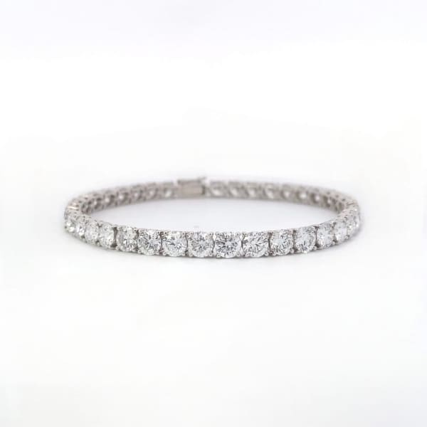 The LGTB007 14K white gold tennis bracelet showcases a seamless line of 6.26-carat round brilliant cut lab-grown diamonds, each securely claw set with four prongs, on a sleek white metal band, elegantly presented against a plain white background.