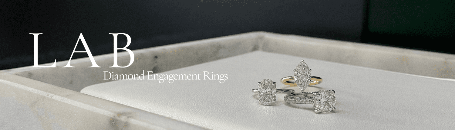 A collection of diamond engagement rings displayed on a white surface, featuring various designs with silver and gold bands. Text on the left reads: "LAB Diamond Engagement Rings.